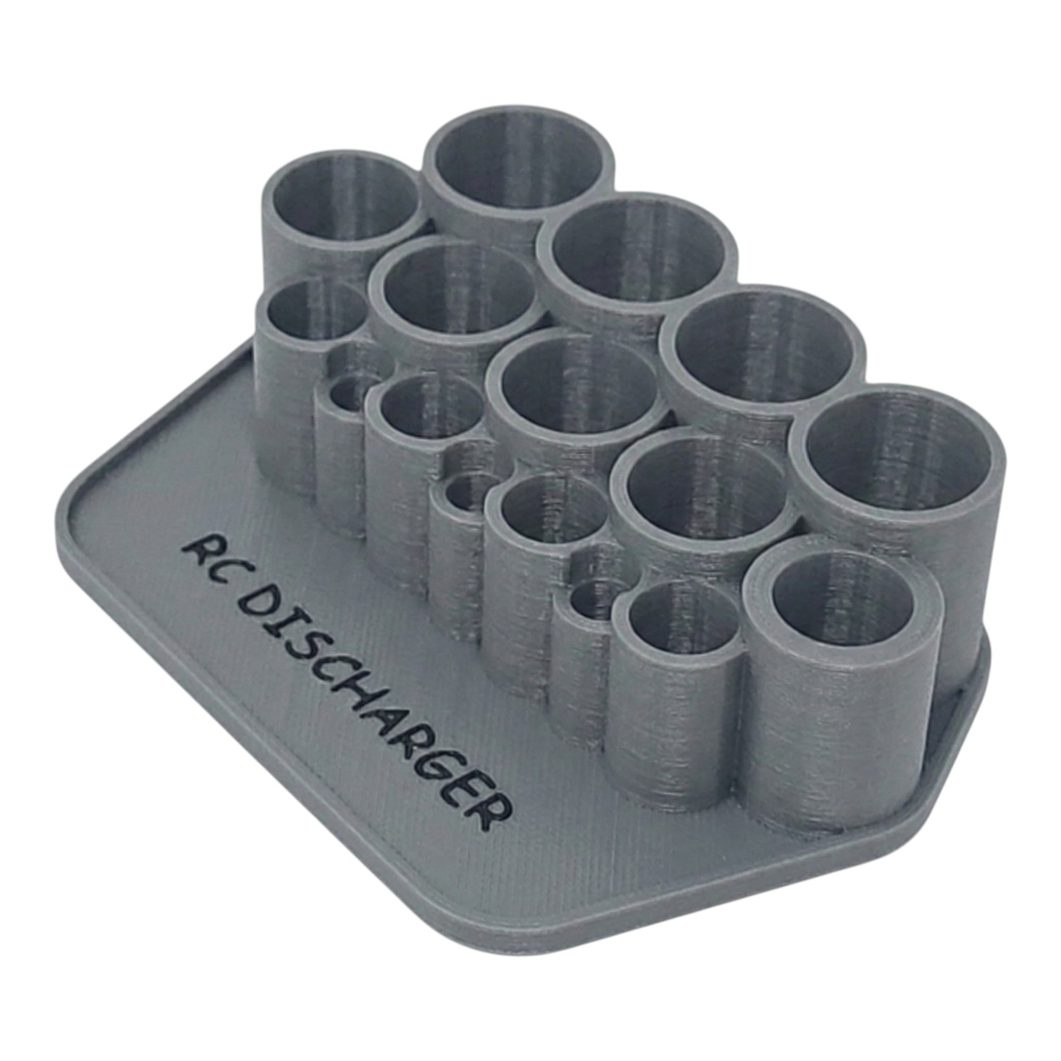 Gray 3D-printed RC discharger holder with multiple cylindrical slots on a rectangular base labeled “RC DISCHARGER”