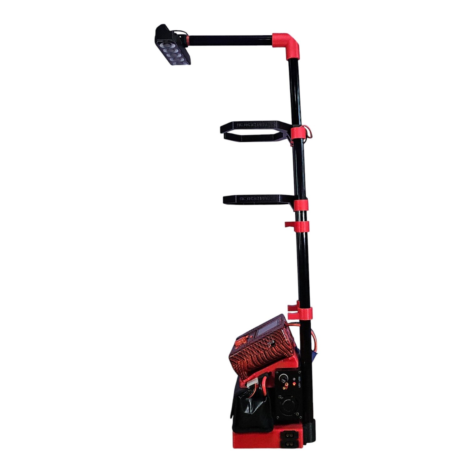 Portable black and red LED work light stand with tool holders and power control panel on white background